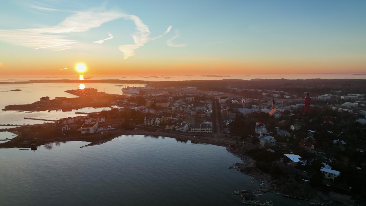 Aerial view overlooking the cityscape of Hanko, spring sunset in Finland - circling, drone shot