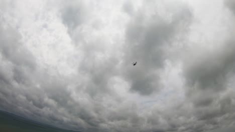 Helicopter-Flying-against-grey-cloudy-background-panning-down-to-panoramic-view-of-Okinawa-and-Pacific-Ocean