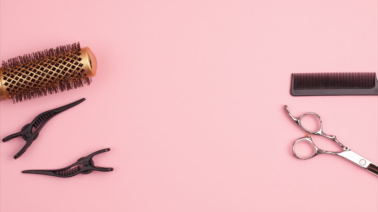 Stop motion animation of professional hair cutting shears, gold round hair brush for styling, comb for separating hair and section hair clips template on pink background. Hairdresser salon equipment