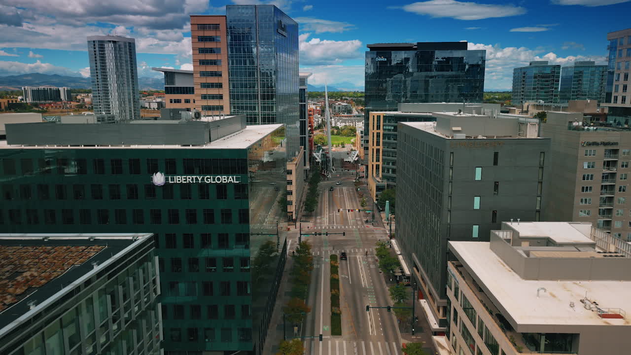 Denver, USA, 24 August 2025: Street with empty multi-lane road along the multi-storied buildings. Urban landscape of Denver, Colorado, USA