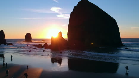 drone footage slowly rising to reveal an amazing sunset in cannon beach on the oregon coast