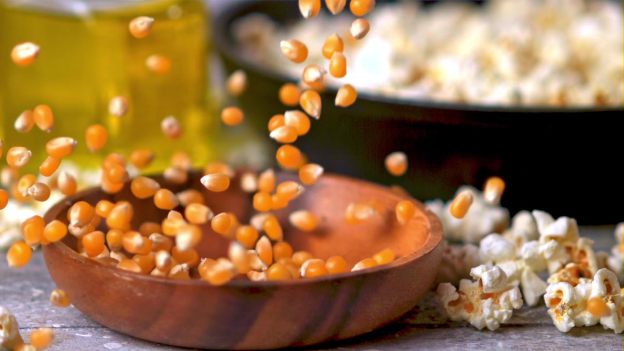 Slow Motion of Popcorn Kernels Falling into a Wooden Bowl