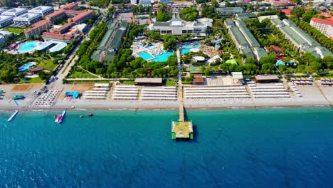 aerial 4k drone wide top down video of a wooden pier near hotel resort in the city of kiriş - kemer