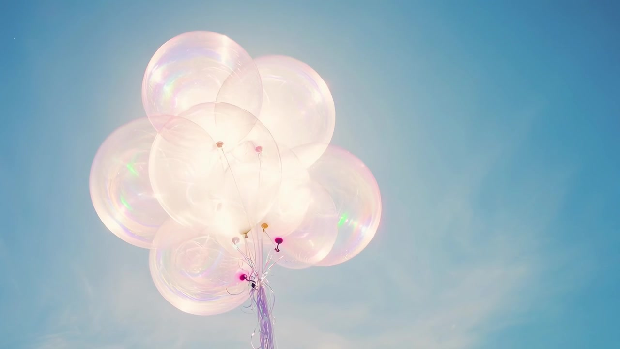 Bunch of Transparent Balloons Floating in a Bright Blue Sky