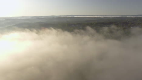 rotating drone shot of fog over oak hills, west virginia