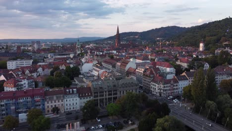 cinematic aerial view of gothic old town landscape of freiburg im breisgau during sunset, germany