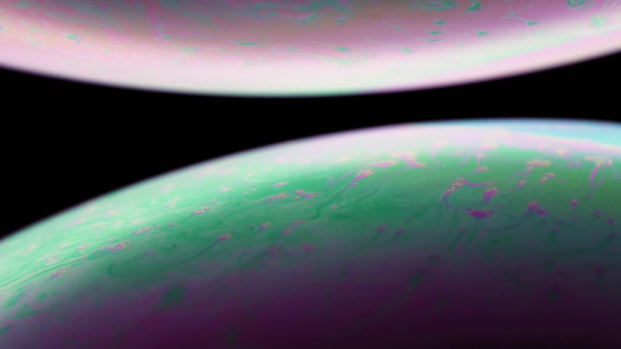 Two spheres of colorful liquid moving