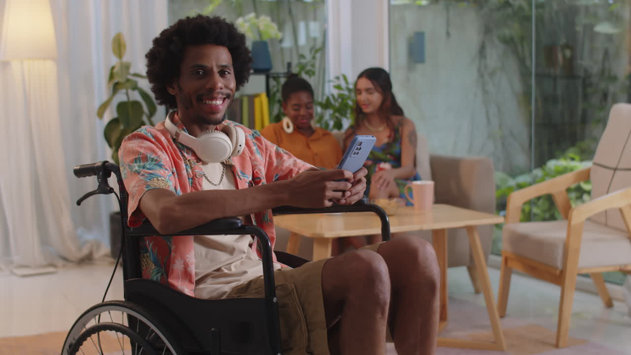 Portrait of Wheelchaired Man Gathering with Friends at Home
