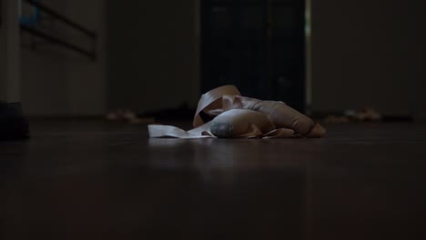 women's ballet shoes fall down on the floor