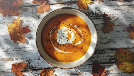 creamy pumpkin soup with fall leaves