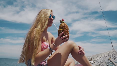 model having a pinacolada during boat trip in buzios - rio de janeiro - brazil