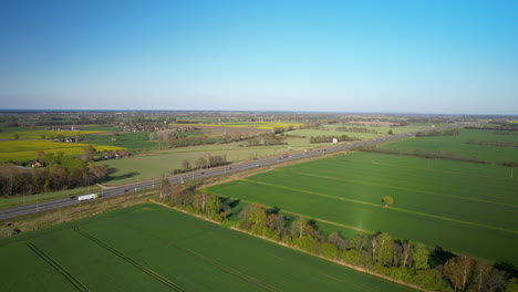 Highway-S7-traffic-pass-through-fertile-countryside-crop-fields,-Gdansk