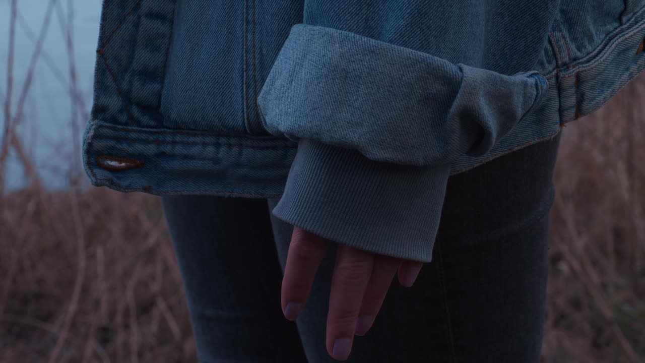 Girl making a Fist in a Jeansjacket - Slowmotion