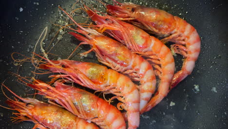 frying fresh shrimps in a pan, cooking fresh catch seafood, 4k shot