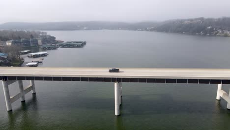 car commuting on highway bridge road crossing ozarks lake, missouri, aerial