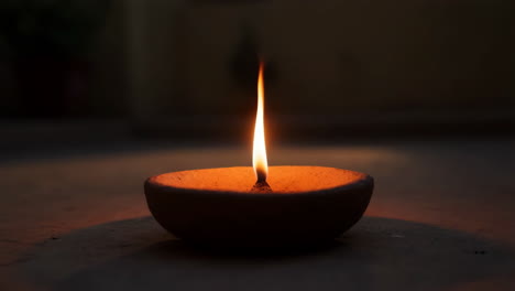 traditional indian oil lamp (diya) glowing in the dark