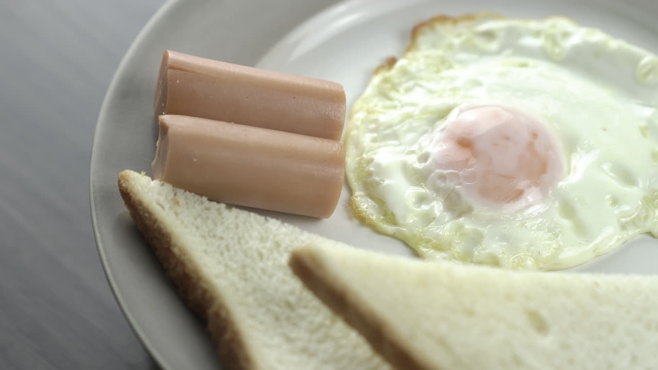 Close Up Shot rotating .Breakfast on a white plate on the right corner of the wooden floor