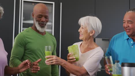 happy senior diverse people cooking in kitchen at retirement home