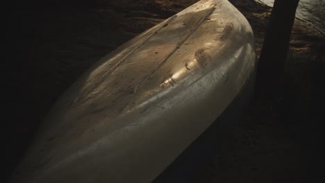 boat resting on shoreline of tropical sandy beach at dusk