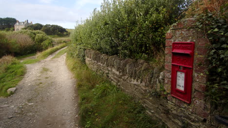 Mid-shot-of-Country-Lane,-with-old-postbox-in-Stonewall-at-Bessy's-Cove,-The-Enys,-cornwall