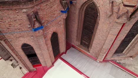 aerial orbit near an old gothic brick construction with metal supports, salvador basilica, santiago chile