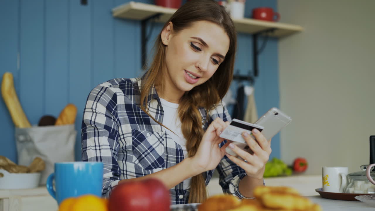 Woman Paying Online in Kitchen