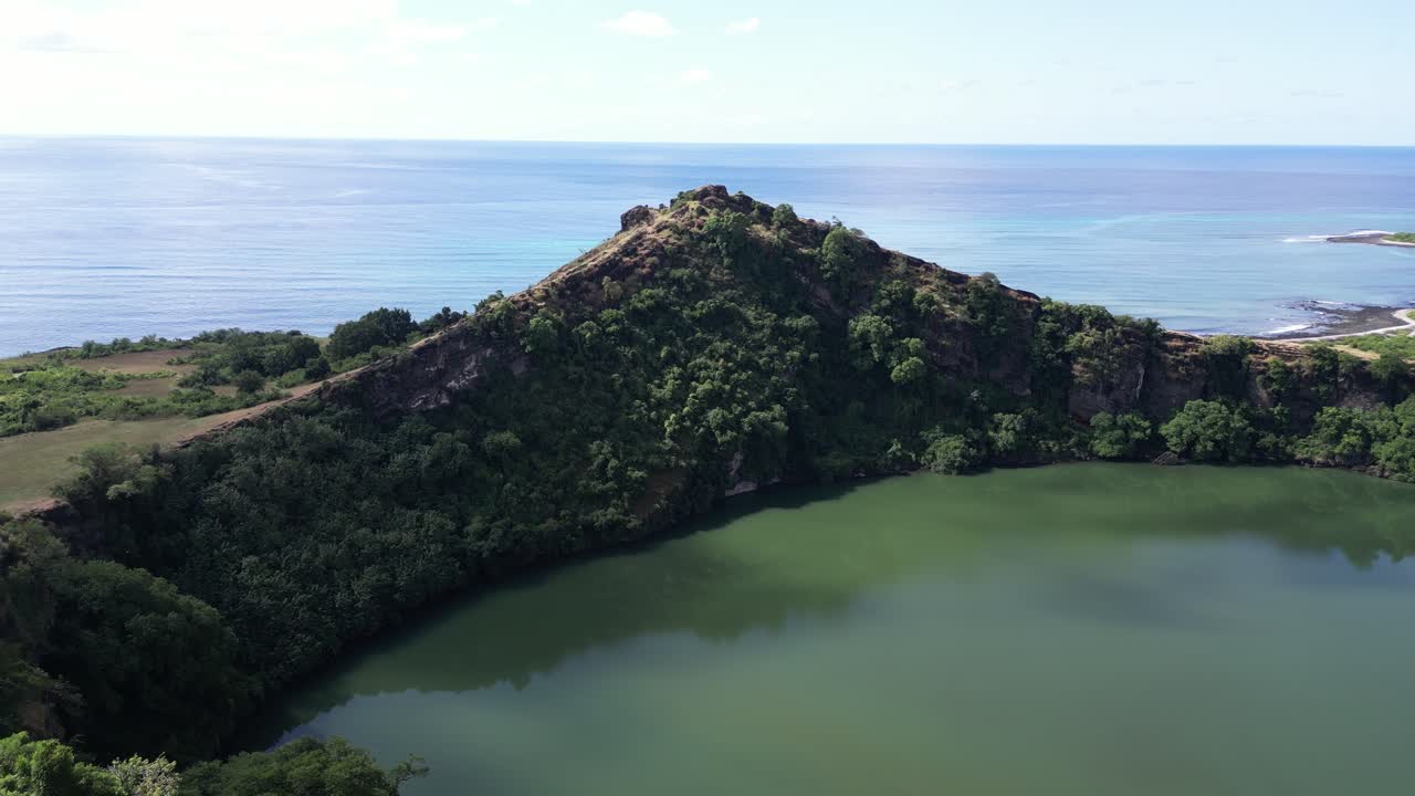 코모로스 섬의 푸른 바다를 내려다보는 절벽과 초록색으로 둘러싸인 푸른 물과 화산 크레이터 호수의 공중 풍경