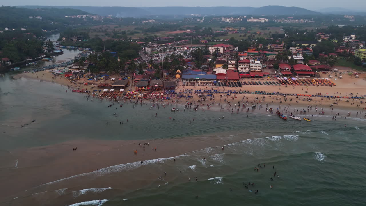 Aerial view circling the crowded Baga beach on a party night in Goa, India