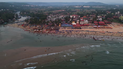 aerial view circling the crowded baga beach on a party night in goa, india