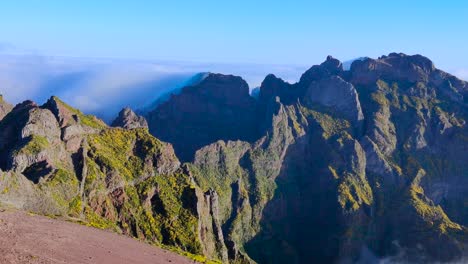 majestic mountain of pico de arieiro peaks above clouds, pan left view