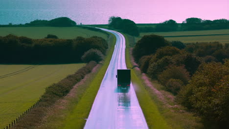 truck on a winding road under a vibrant purple sky