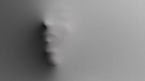a creepy silhouette of a woman's face appears screaming from the white surface