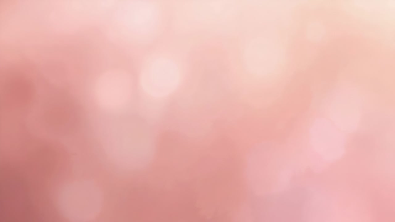 Campo bokeh rosa suave y cambiante que se acerca en primer plano debido a un ligero cambio de enfoque y a las luces que cambian.