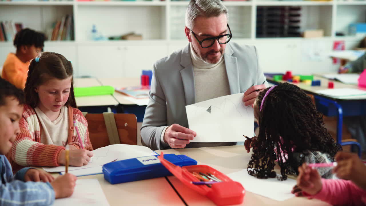 Teacher assisting students with their drawings in the classroom