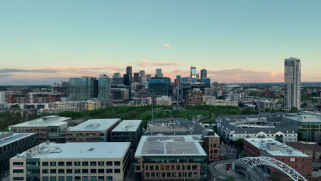 Aerial-approach-over-Highland-Bridge-toward-Commons-Park,-Denver-skyline-view