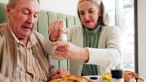 elderly couple enjoying a meal at a cafe