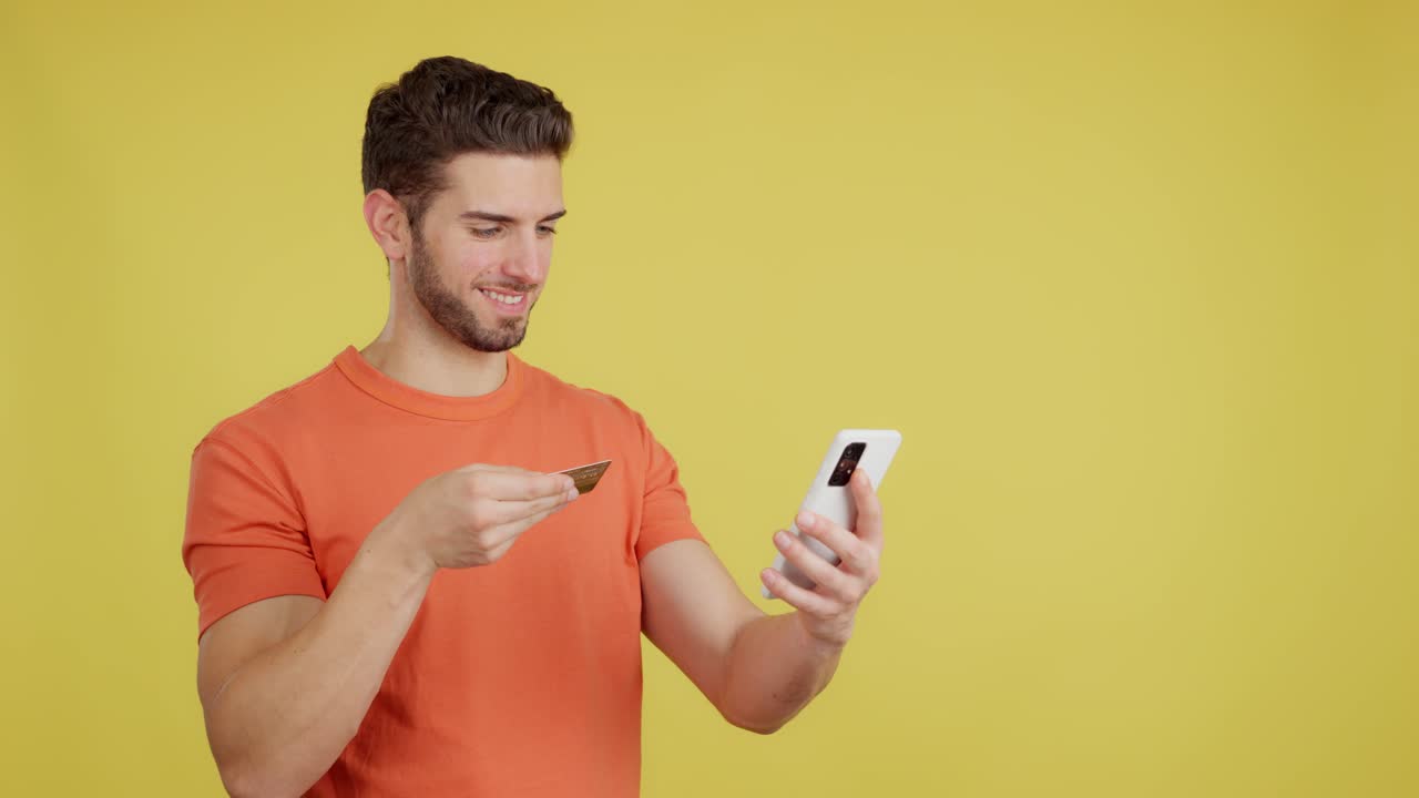 Man making an online purchase with a credit card and smartphone