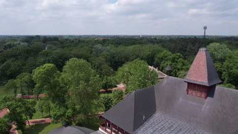 Aerial-View-of-Palic-Lake-Park-and-Grand-Terrace-Building,-Vojvodina,-Serbia,-Revealing-Drone-Shot