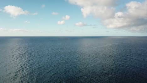Steady-drone-ocean-horizon-blue-day