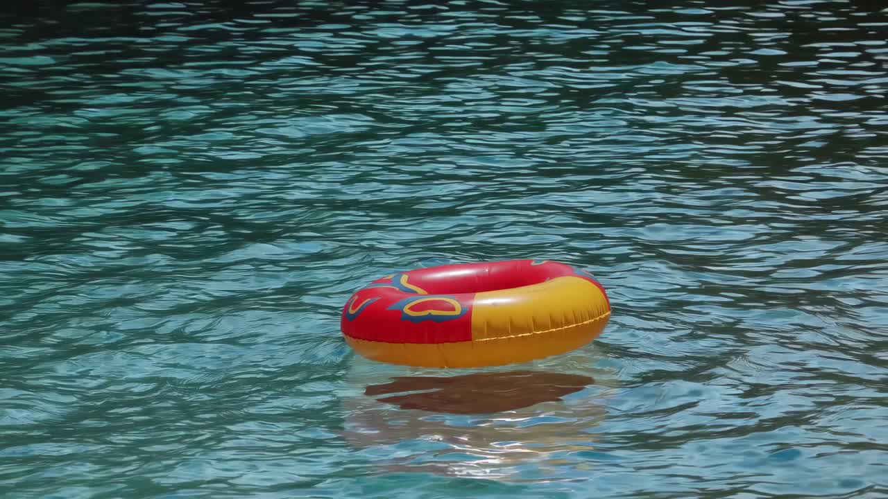 Red and Yellow Inflatable Pool Ring Floating in Water