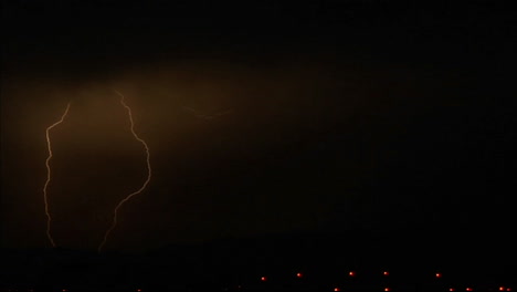 lightening strikes illuminate a hillside 1