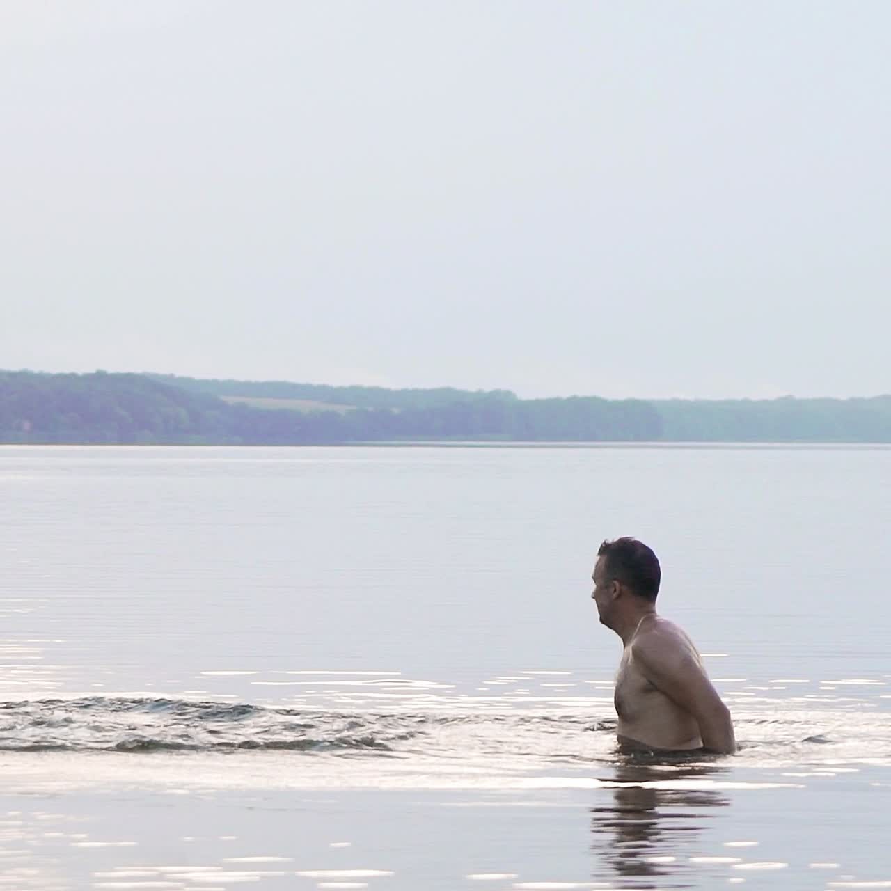 Jumping in the water. Man and boy are having fun and splashing in the water. Summer holiday concept