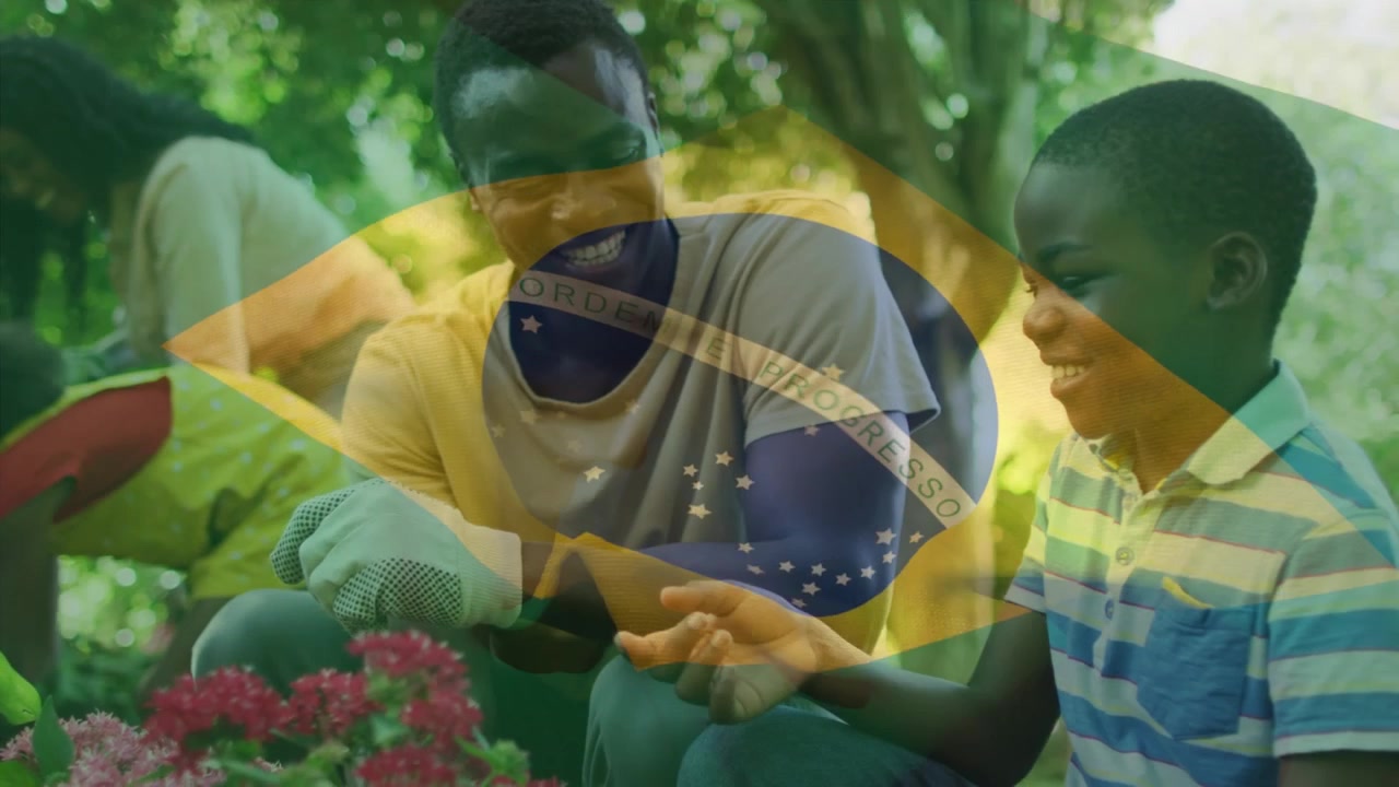 Animazione della bandiera del Brasile su un uomo afroamericano e suo figlio.