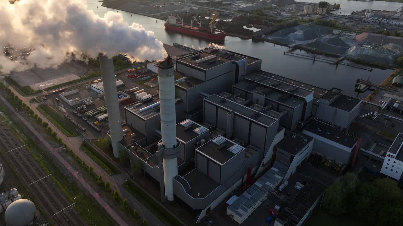 waste incineration facility, smoke, chimney, industrial process, climate change, heavy industry. Port of Amsterdam, The Netherlands. Aerial view.