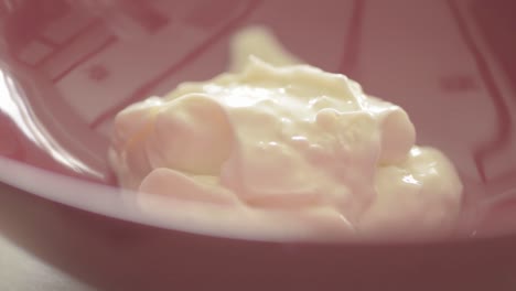 spooning creamy yoghurt into a bowl