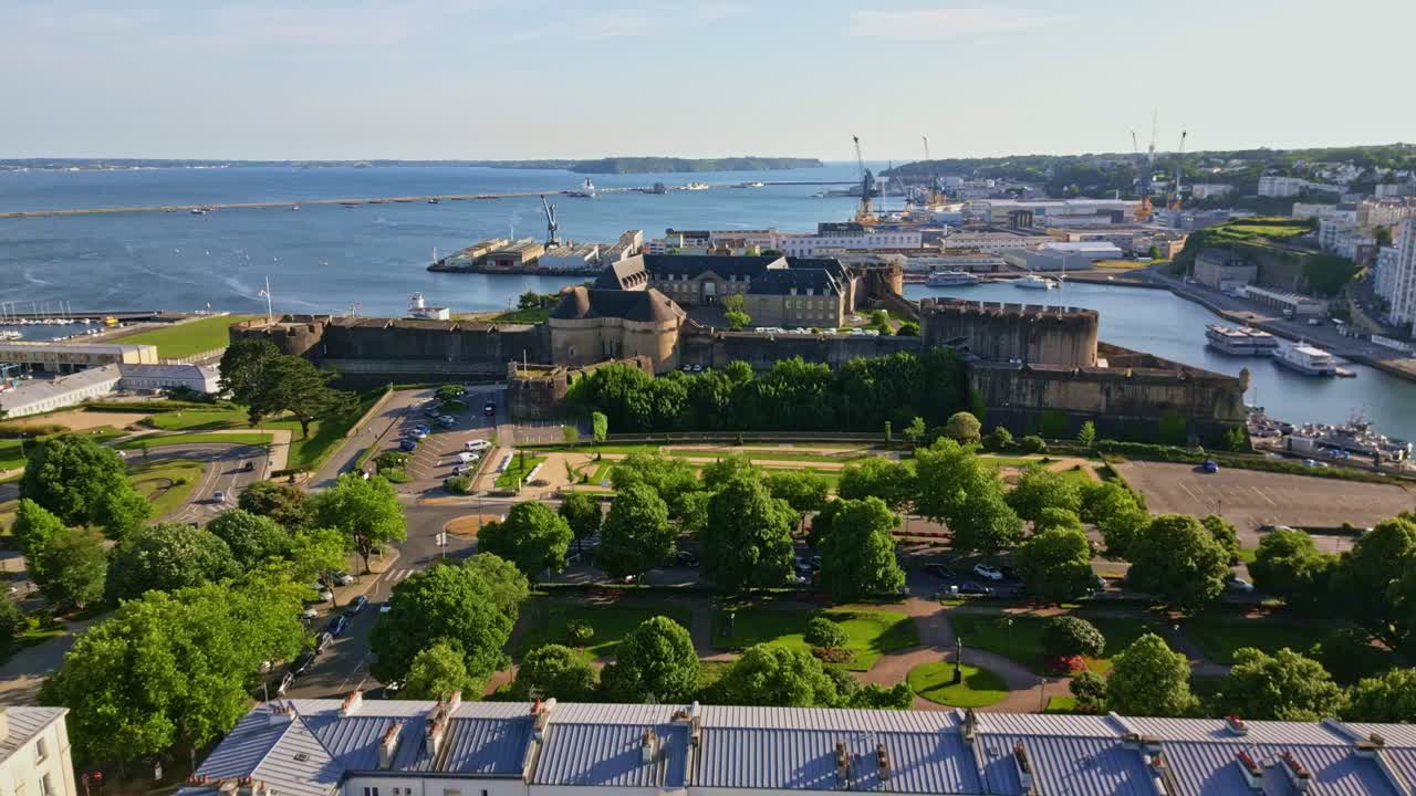 National Maritime Museum in Brest with waterfront and historic buildings, France, midday aerial establish pullback