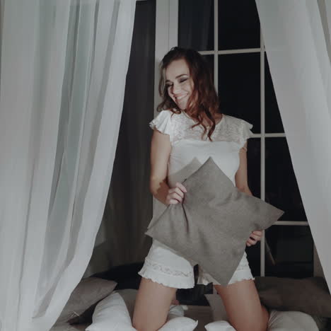 beautiful brunette woman with attractive body in lacy nightwear, posing on camera. fashionable portrait of the model in the room.