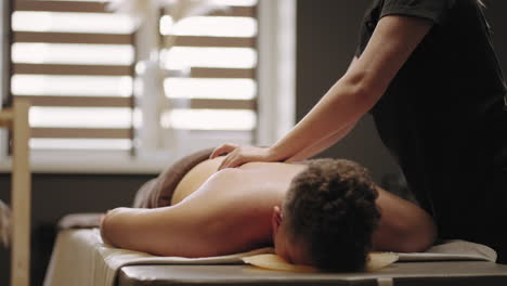 woman-massage-master-is-massaging-male-body-in-spa-salon-relax-treatment-for-rest-and-cure-osteochondral-disease