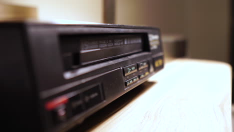 Stopping-and-Ejecting-VHS-Video-Tape-From-Player,-Close-Up