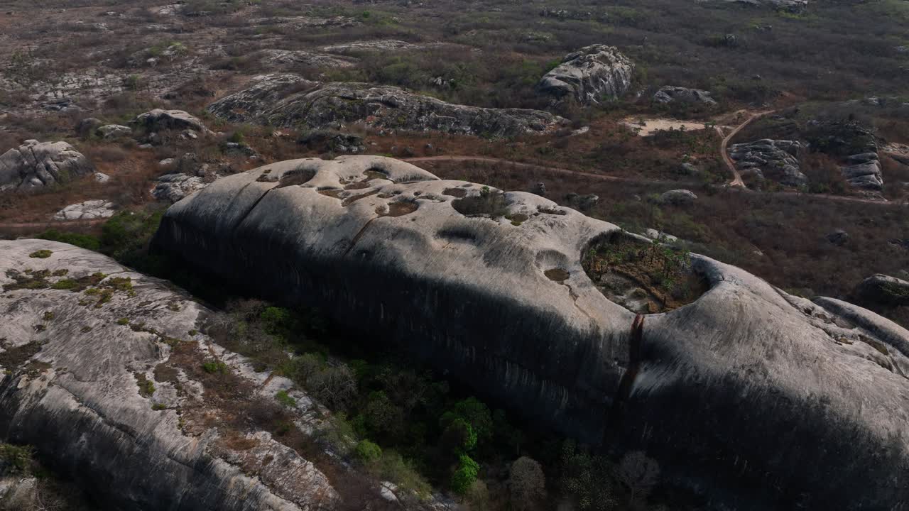 Aerial pull back shot of rocky terrains and arid background at Chaval Ceara in Brazil